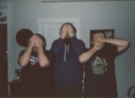 Press photo of Boston band Idle Pilot. Each member of the band is covering their faces with their hands, which have eyes painted on