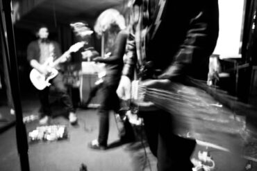 Blurry photo of Bedroom Eyes playing live on stage