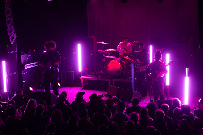 full body 2 performs on the sinclair stage with purple light enveloping them
